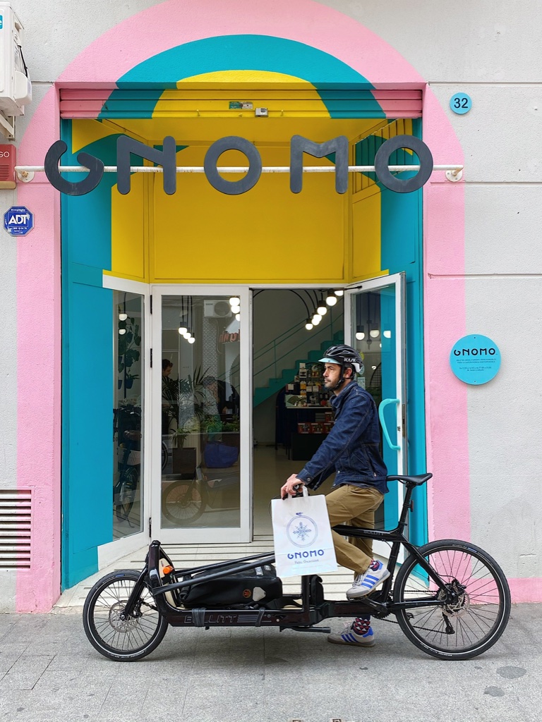 Bolsa de papel blanca con asa troquelada para presentar productos en tienda