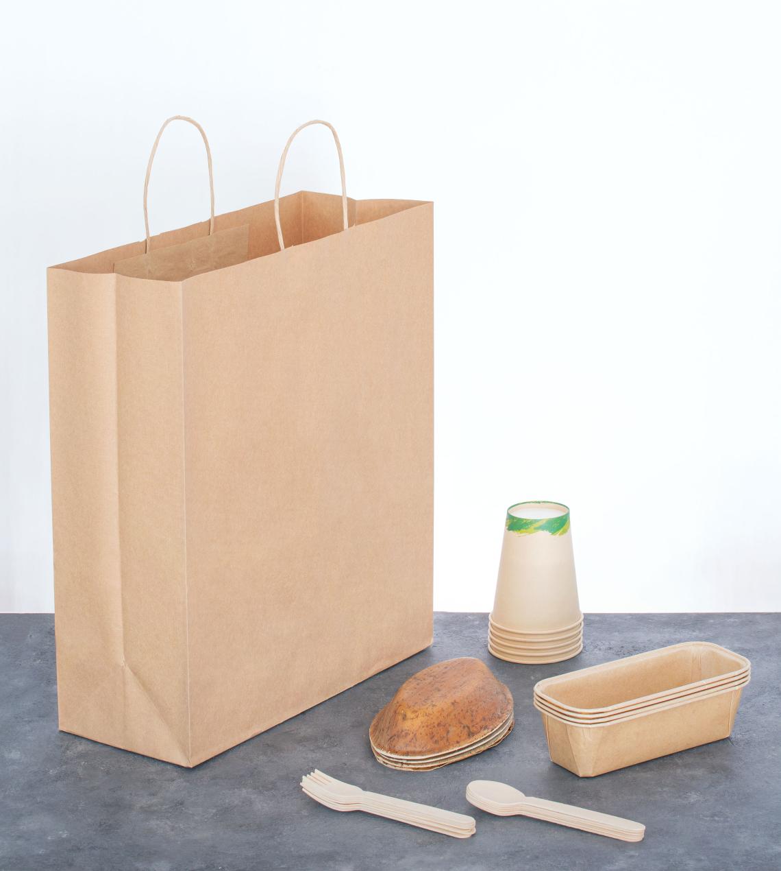 Bolsas grandes de papel reciclado take away junto a platos de comida