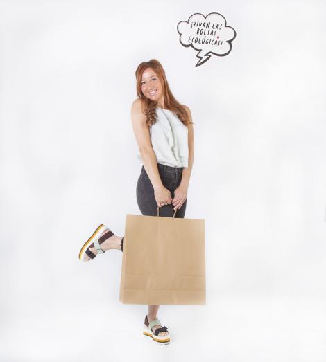 Bolsas de papel kraft grandes sujetas por una mujer