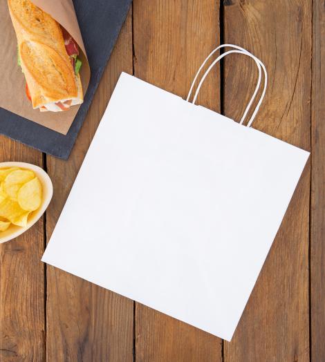 Bolsas de papel ecológico con base ancha Bolsas take away blancas con comida al lado