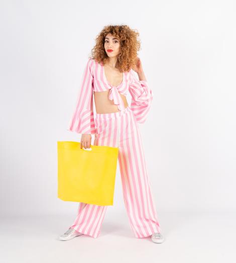 Bolsas con asas troqueladas grandes sujetadas por una mujer